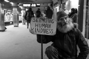 Homeless man in Langley holding a sign